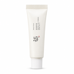 ELUNEA Rice Sun Cream SPF50+ — protector solar facial coreano con acabado glow natural, packshot sobre fondo ivory